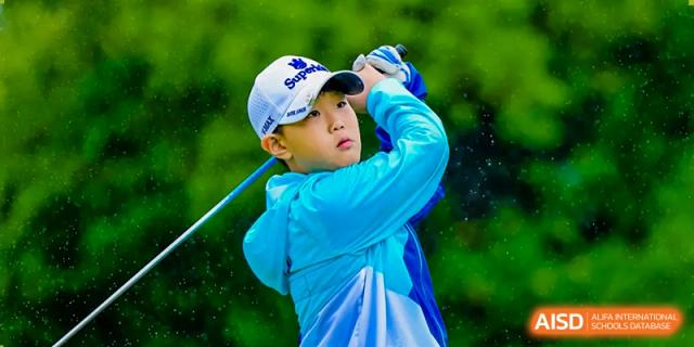 A Nord Anglia Chinese International School Shanghai student in blue sports gear taking a swing during a golf game.