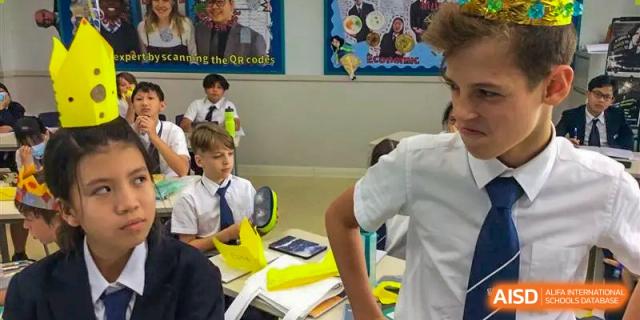 Students working at desks in a bright classroom with posters on the wall at Nord Anglia International School Shanghai, Pudong.