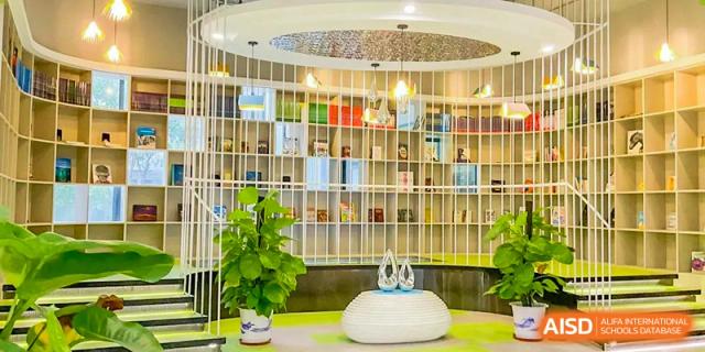 A cozy reading area in the RDF International School library with floor-to-ceiling shelves and a white, rounded seat.
