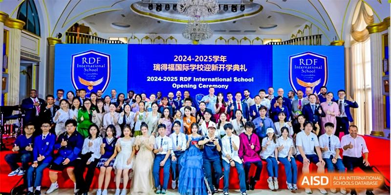 A large group of students and faculty posing together for the 2024-2025 Opening Ceremony at RDF International School.