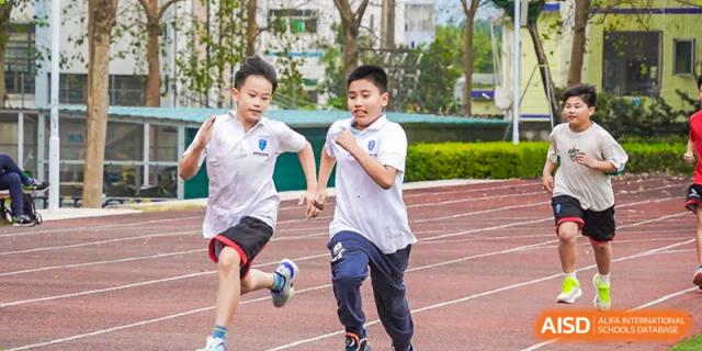Young students running a sprint race on the track at RDF International School.