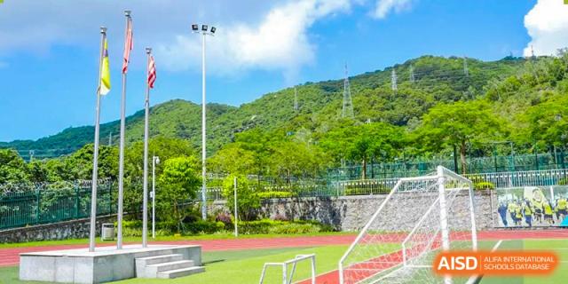 The outdoor soccer or football field with green turf surrounded by hills at RDF International School.
