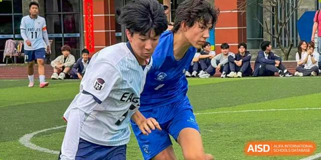 Two RDF International School students competing for the ball during a sports match.