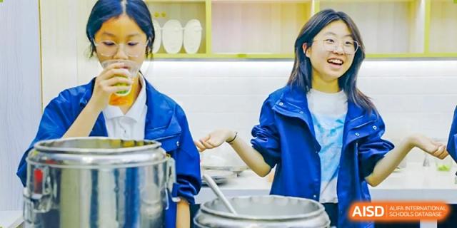 Students at RGS Guildford Nanjing cooking or preparing food in a kitchen area.