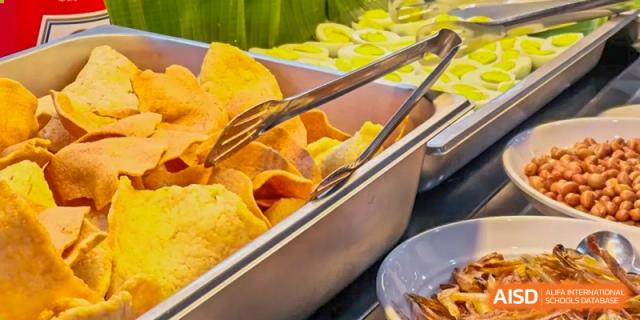 A close-up shot of a tray of tortilla chips or fried snacks served at RGS Guildford Nanjing.