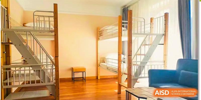 A simple, clean dormitory room interior featuring two bunk beds, likely for student accommodation at Shanghai DTD Academy.