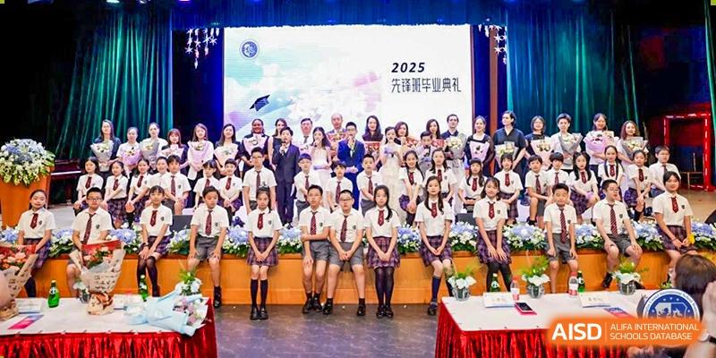 A large group photo of students and teachers, with a "2025 Graduation Ceremony" banner visible on the screen behind them, at Shanghai United International School, Wanyuan Campus.