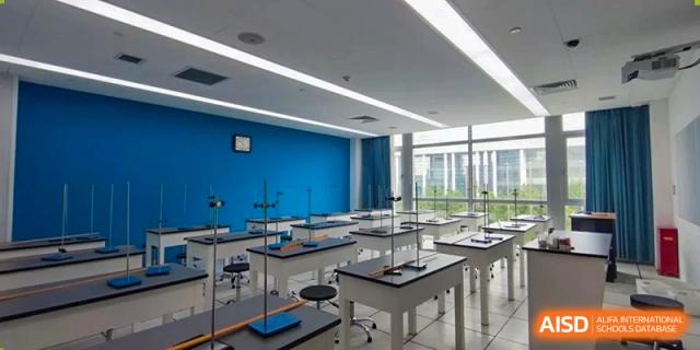 A spacious, modern science laboratory at SHENGHUA ZIZHU ACADEMY with blue walls, lab benches, and specialized equipment for chemistry or biology.