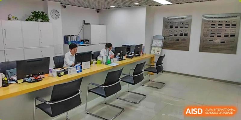 A row of modern computer workstations and office chairs in an administrative or resource center at SHENGHUA ZIZHU ACADEMY.