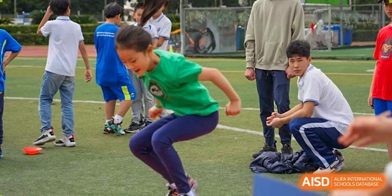 A student leaping or jumping during a physical education or sports training session at Shenzhen American International School.