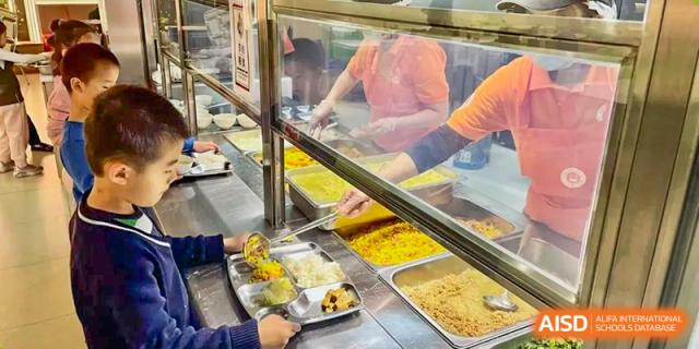 A close-up view of a variety of dishes being served in the school canteen at Shenzhen American International School.