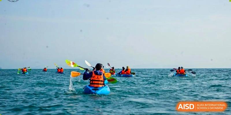 Students in kayaks paddling in the ocean during an outdoor adventure activity at Shenzhen College of International Education.