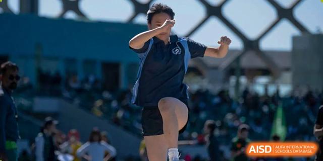 A close-up of a student in a dark sports uniform during an athletic activity at Shenzhen College of International Education.