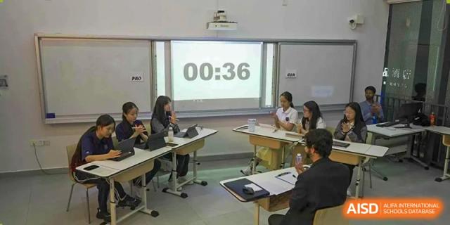 Students taking a timed quiz or exam with a digital countdown displayed on the wall at Shenzhen International Foundation College (SIFC).
