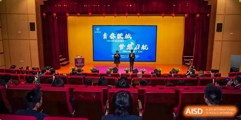 A presentation or awards ceremony taking place on a stage at Suzhou Innovation Academy under a banner reading "YOUTH BLOOMS".