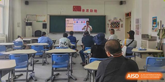 Students sitting in a traditional classroom at Walton International School Xuzhou, facing the front where a presentation is being shown.