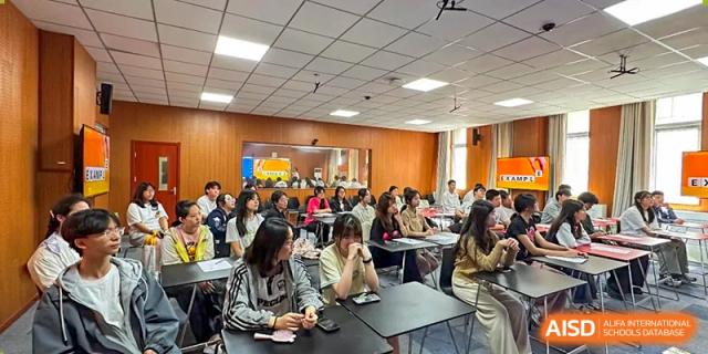 Students engaged in a class or seminar, seated at tables and taking notes at Walton International School Xuzhou.