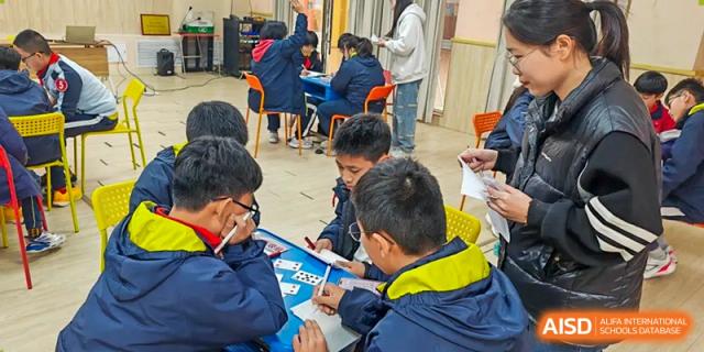 Students working together on a group project or activity, collaborating at their desks at Walton International School Xuzhou.