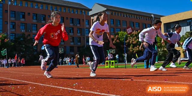 A female student running a race on the red track during a sports meet at Walton International School Xuzhou.