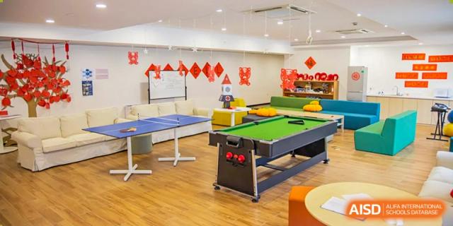Indoor recreation room with a pool table and ping pong table at Wycombe Abbey School Hangzhou.