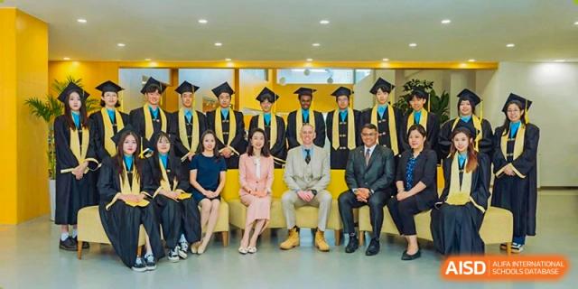 A group of graduating students and faculty from Xi'an Liangjiatan International School pose together in graduation caps and gowns.