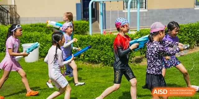 Xiamen International School students participating in an outdoor fun run or sports day activity.