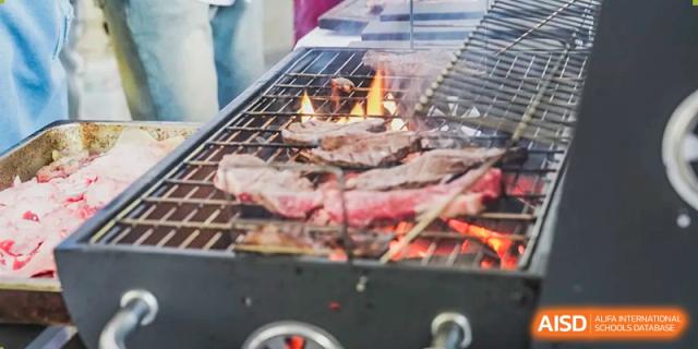 Meat grilling on a barbecue at a Xiamen International School event or school fair.
