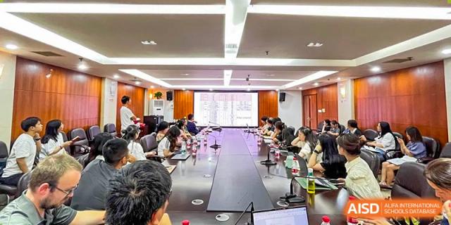 A large group meeting or conference taking place in a boardroom at Yali High School International Department.
