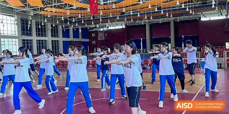 Yali High School International Department female students participating in a group indoor exercise or dance.