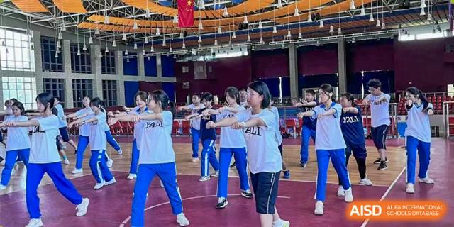 Yali High School International Department female students participating in a group indoor exercise or dance.