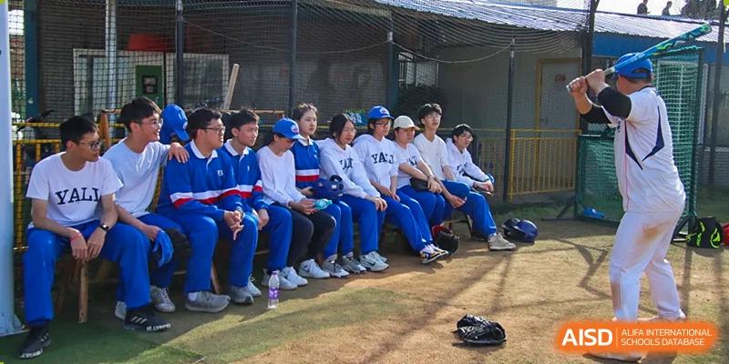 A group of Yali High School International Department students sitting together, possibly watching a sports game.