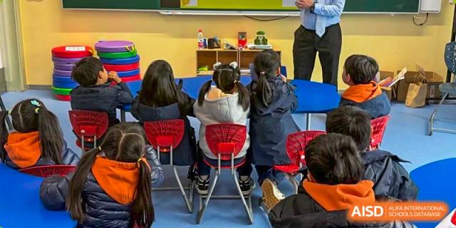 Students from Yew Wah International Education School of Zhejiang Tongxiang seated in a classroom working on a project or activity.