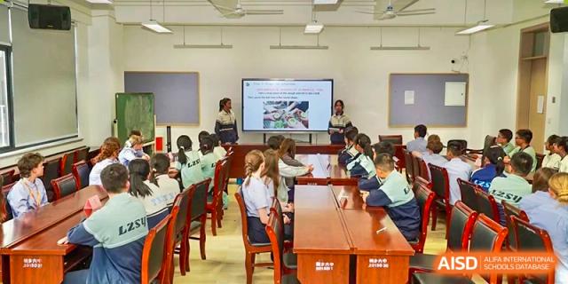 Classroom at Yew Wah International Education School of Zhejiang Tongxiang with students seated, focused on a projection screen.