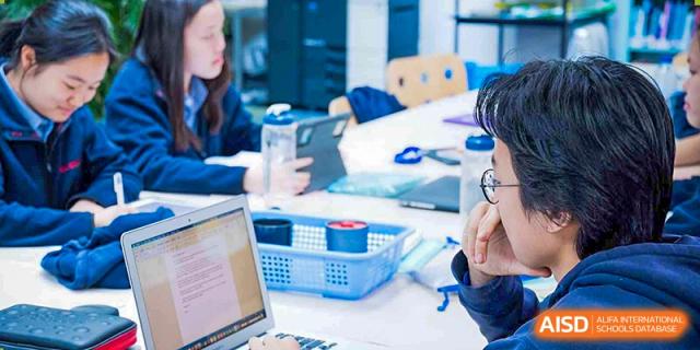 Student at Yew Wah International Education School of Zhejiang Tongxiang working on a laptop during an in-class activity.