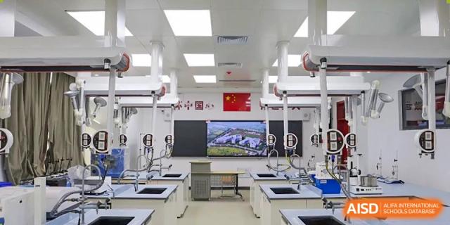 A modern laboratory classroom with multiple workstations, monitors, and equipment for science or technology learning at Zibo MacDuffie Bilingual High School.