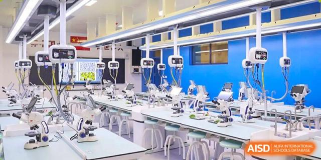A wide shot of a brightly lit, modern science laboratory with rows of lab benches and specialized equipment at Zibo MacDuffie Bilingual High School.