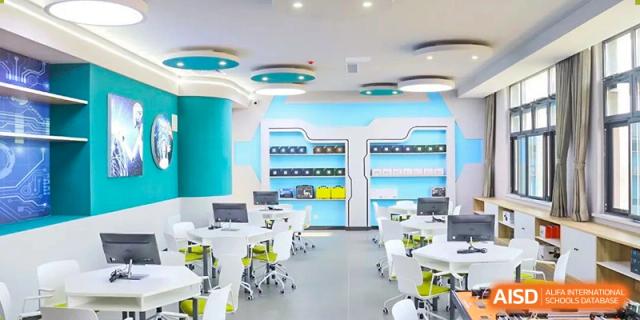 A brightly colored, futuristic-looking classroom or laboratory with light-blue and white accents and modern desks at Zibo MacDuffie Bilingual High School.