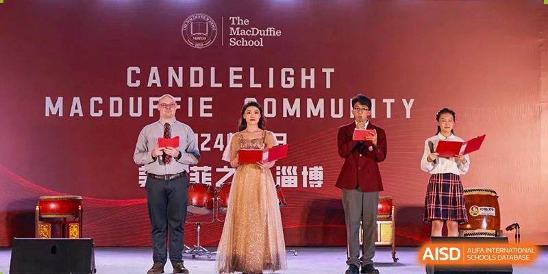 A student performance with a female student singing on stage in a gown, accompanied by a male student in a suit at Zibo MacDuffie Bilingual High School.