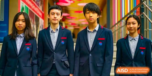 A portrait of two male Yew Wah International Education School of Yantai Campus students in their school blazers.