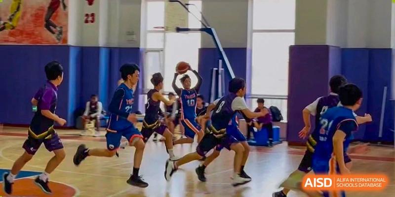 Basketball players from Yew Wah International Education School of Yantai Campus in action during a game on the court.
