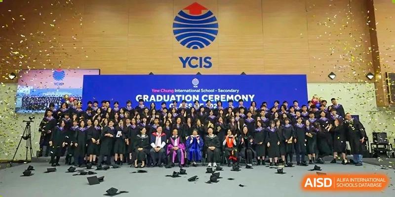 Group photo of graduates and teachers at the Yew Wah International Education School of Yantai Campus graduation ceremony.