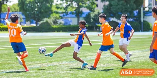 Yew Wah International Education School of Yantai Campus students playing football (soccer) during a sports match.