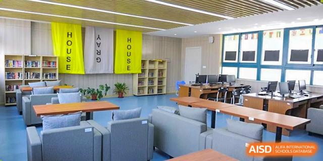 Another view of the student common area at Wenzhou No.22 Senior Middle School, showing multiple seating arrangements and the "HOUSE YELLOW" and "HOUSE GRAY" banners.