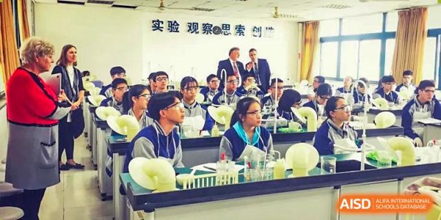 Wenzhou No.22 Senior Middle School students attentively listening to an instructor or guest speaker in a classroom with a sign in Chinese.