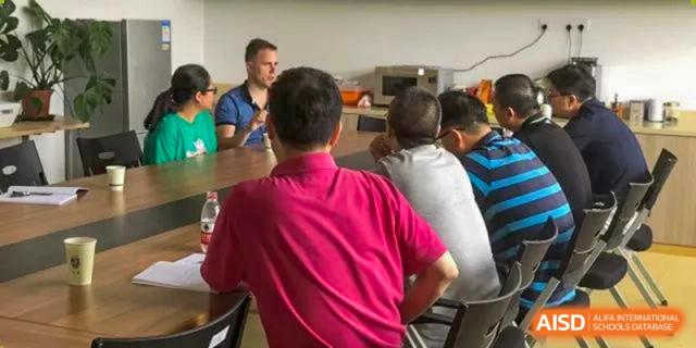 Wenzhou No.22 Senior Middle School students and teachers gathered around a table for a casual meeting or discussion.