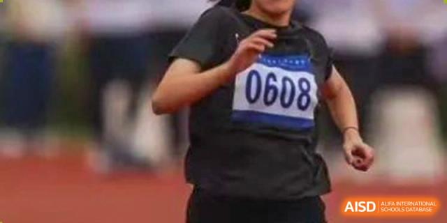 Close-up of a Wenzhou No.22 Senior Middle School student wearing bib number 0608 while running on a track during a sporting event.