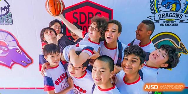 A group of diverse students at Shekou International School celebrating together after a basketball game, showcasing strong friendship and team spirit.
