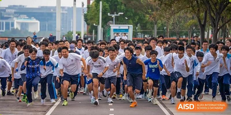 A group of students starting a running race outdoors during a sports day event at Shanghai Nanyang Model Private School.