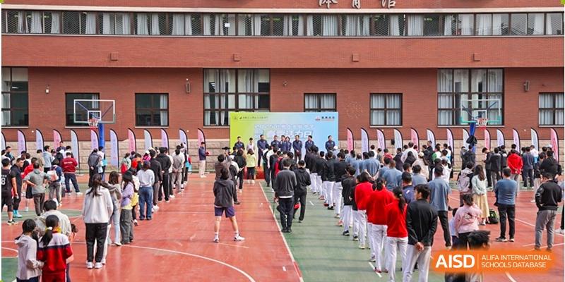 Students from Chengdu Experimental Foreign Languages School International Department marching or walking in a formal line outside a campus building, possibly for an event or ceremony.