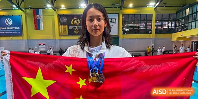 A triumphant Chengdu Experimental Foreign Languages School International Department student athlete wearing a gold medal and holding the Chinese flag draped over their shoulders.